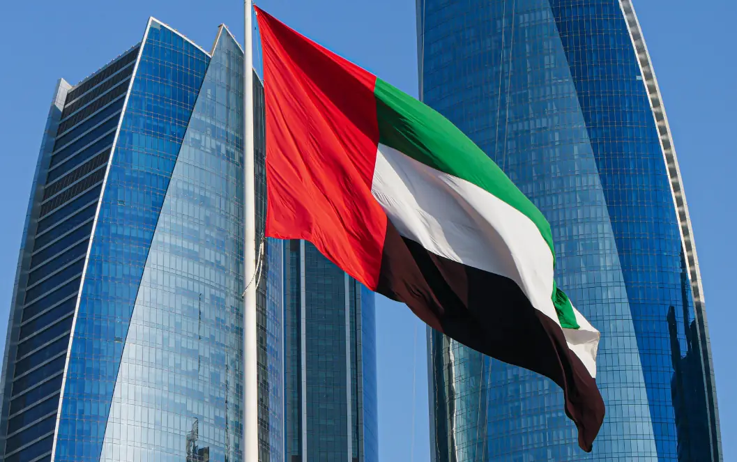 UAE flag in front of glass towers for the healthcare marketing Dubai overview, supporting local search and Google Maps