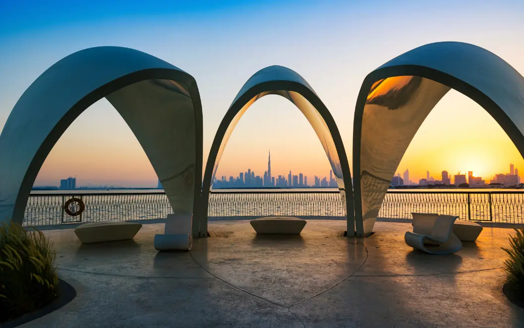 Healthcare marketing Dubai: Curved waterfront shelters framing the Dubai skyline at sunset for Measure Dubai growth by location and service line