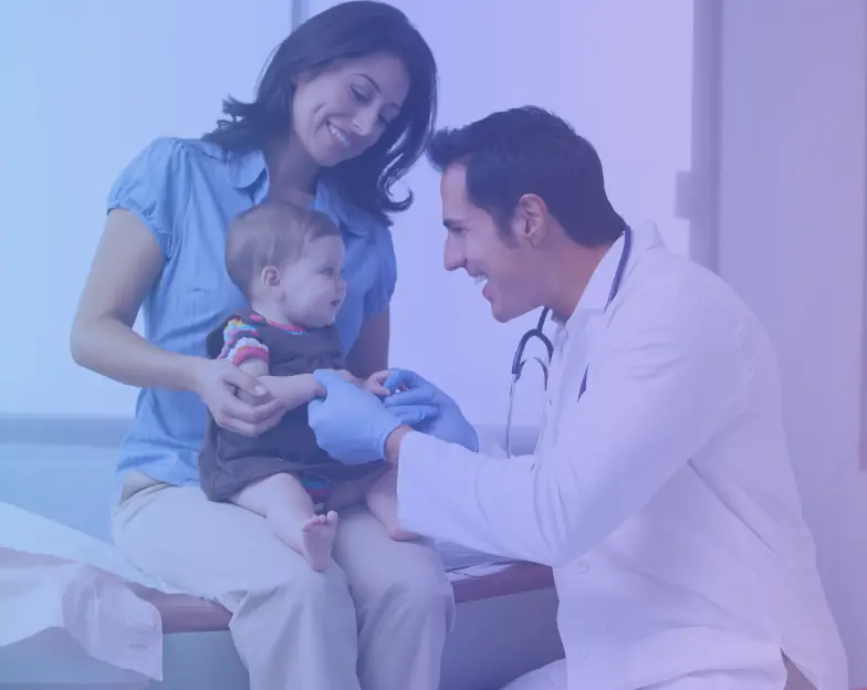 Medical and dental marketing in UAE: Clinician examining a young child seated with an adult in a family-care setting for Family Medicine and Primary Care, supporting specialty-led healthcare marketing