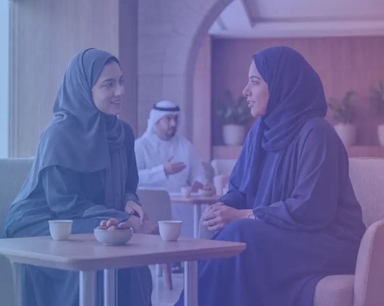 Medical and dental marketing in UAE: Two women talking at a table in the women's health and paediatrics service tile, supporting specialty-led healthcare marketing