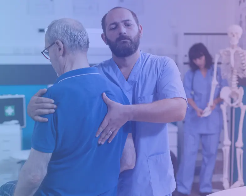 Medical and dental marketing in UAE: Clinician supporting an older man's shoulder during a movement assessment for Orthopaedics, Sports Medicine and Pain Care