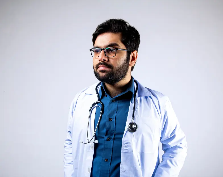 Medical and dental marketing in UAE: Clinician in glasses and a white coat holding a folder for Independent Specialist Clinics, supporting specialty-led healthcare marketing