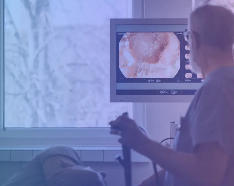 Medical and dental marketing in UAE: Clinician viewing a close-up examination image on a medical monitor for Gastroenterology and Urology, supporting specialty-led healthcare marketing