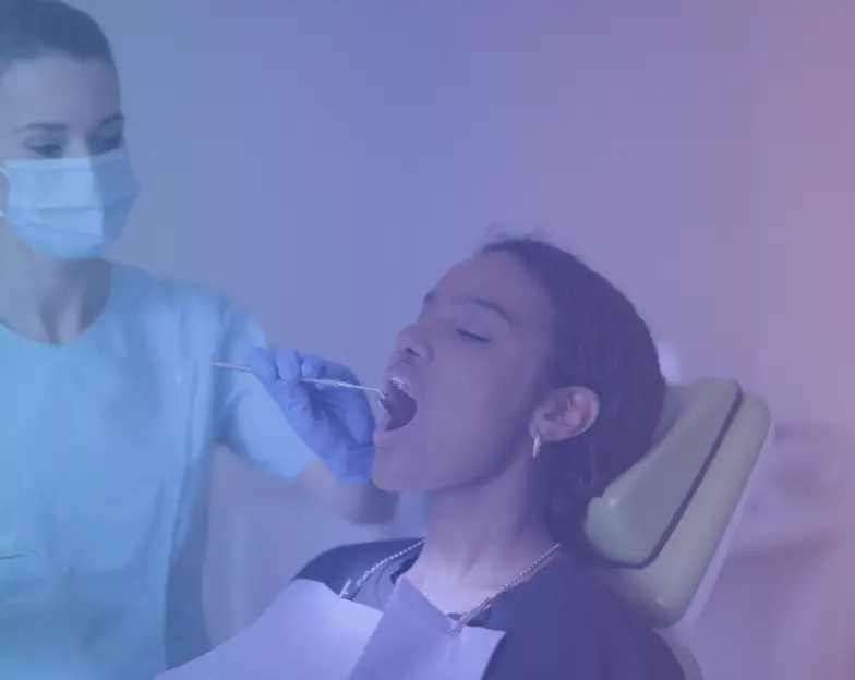Medical and dental marketing in UAE: Dental professional examining a seated woman's mouth for General and Family Dentistry
