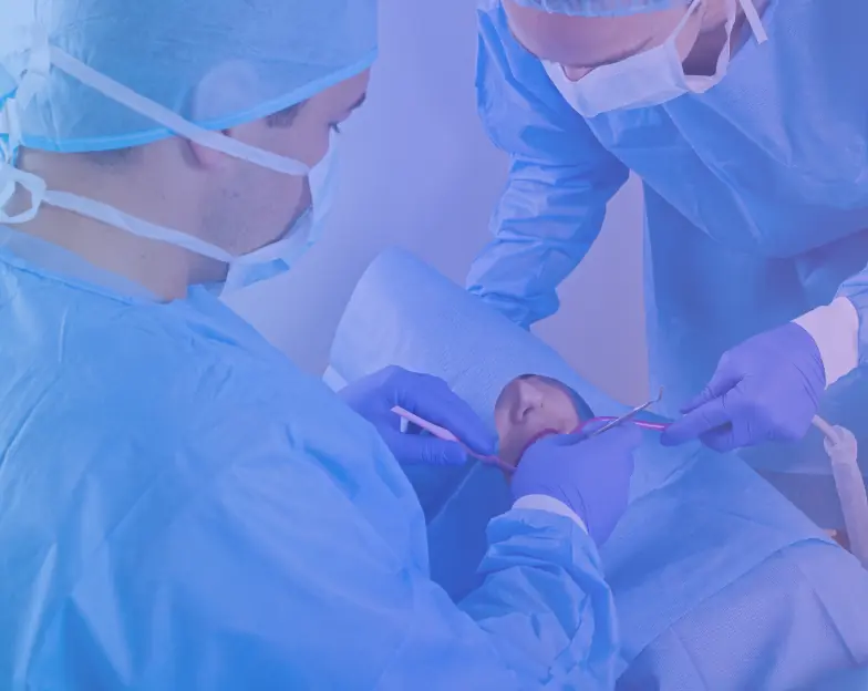 Medical and dental marketing in UAE: Dental surgical team working over a reclining person for Implant Dentistry and Oral Surgery