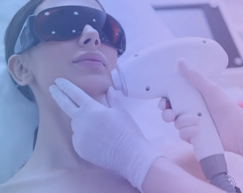 Medical and dental marketing in UAE: Handheld treatment device near a woman's face as she wears protective goggles for Laser and Device-Based Treatments, supporting aesthetic clinic marketing UAE