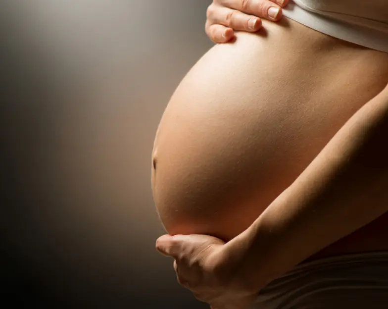 Medical and dental marketing in UAE: Hands resting around a rounded abdomen in the fertility-clinic overview
