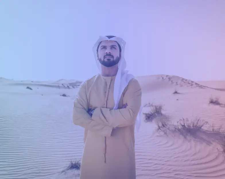 Medical and dental marketing in UAE: Man in traditional Gulf clothing standing among sand dunes for Male Fertility Services