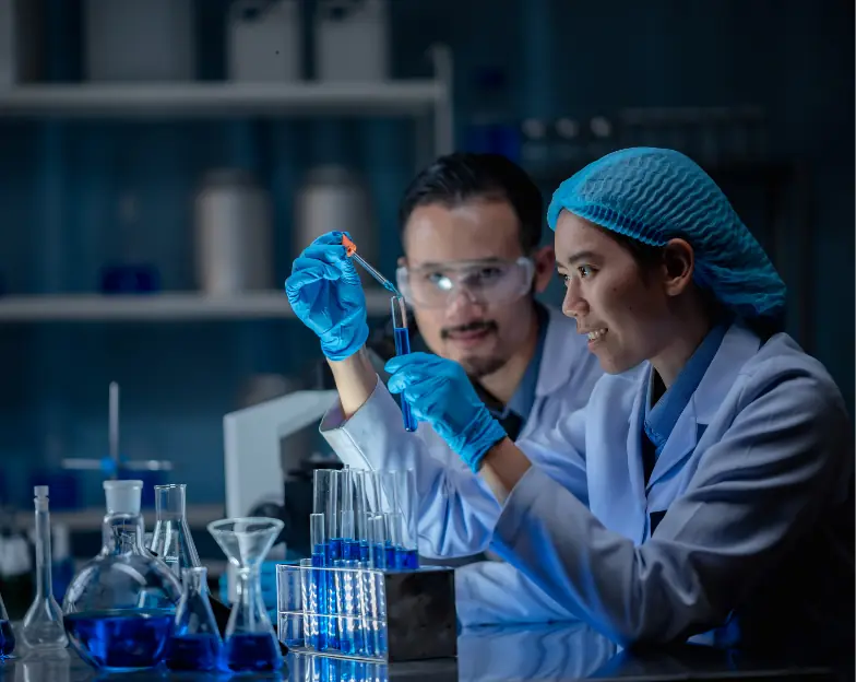 Medical and dental marketing in UAE: Two laboratory professionals examining a sample tube at a workbench for Diagnostic Centres