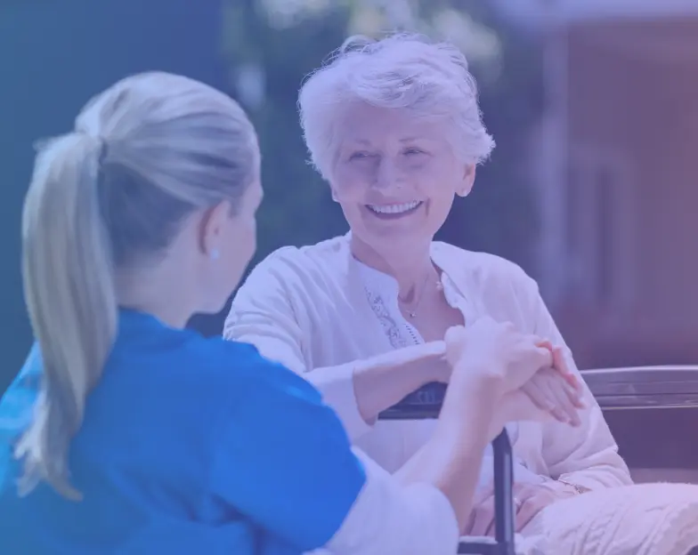 Medical and dental marketing in UAE: Caregiver and older woman holding hands during a home-care visit for Home Nursing Services