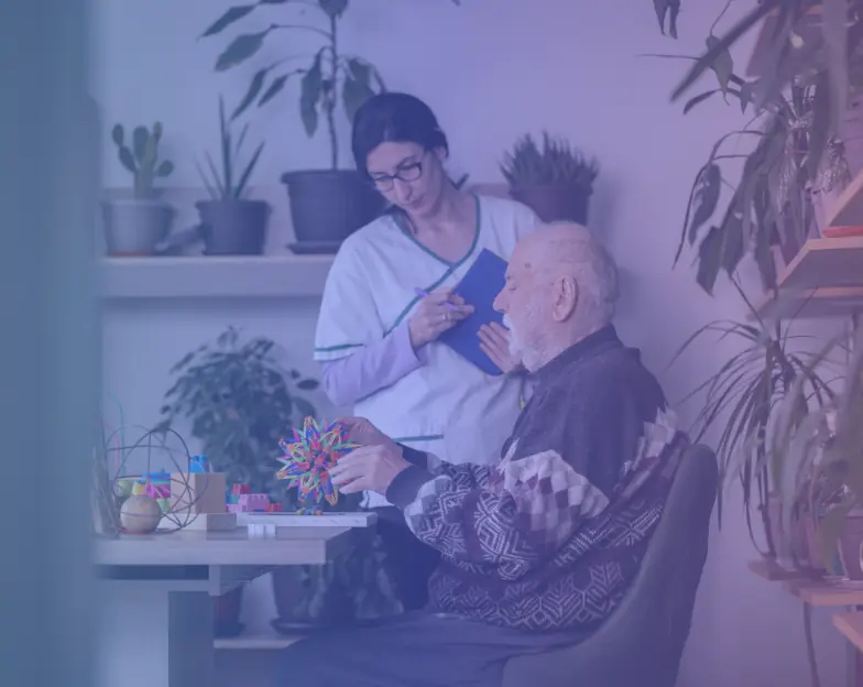Medical and dental marketing in UAE: Care worker speaking with an older man in a living room for Ongoing and Long-Term Home Support, supporting specialty-led healthcare marketing