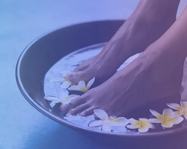 Medical and dental marketing in UAE: Feet resting in a spa bowl with flowers for Spa and Relaxation Services, supporting beauty marketing UAE