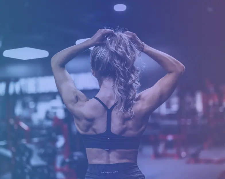 Medical and dental marketing in UAE: Woman preparing for exercise in a gym studio for Boutique and Group Fitness Studios, supporting fitness and wellness marketing UAE