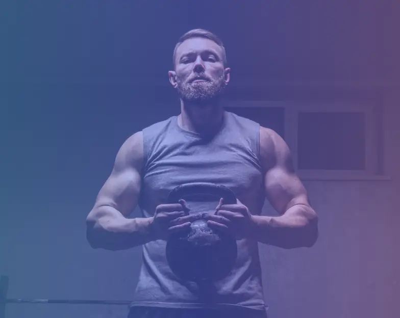 Medical and dental marketing in UAE: Man holding a kettlebell during a gym workout for Personal Training and Coaching Businesses, supporting fitness and wellness marketing UAE