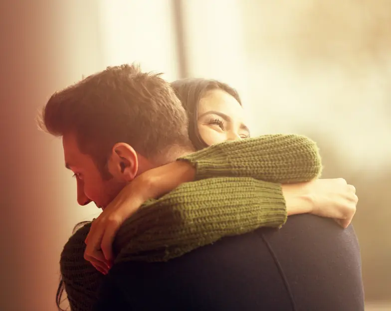 Medical and dental marketing in UAE: Two people embracing in warm indoor light for Longevity and Preventive Health, supporting fitness and wellness marketing UAE