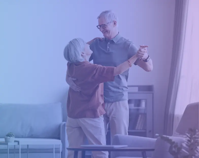 Medical and dental marketing in UAE: Older couple dancing together in a living room for Preventive and Executive Health Programmes, supporting specialty-led healthcare marketing