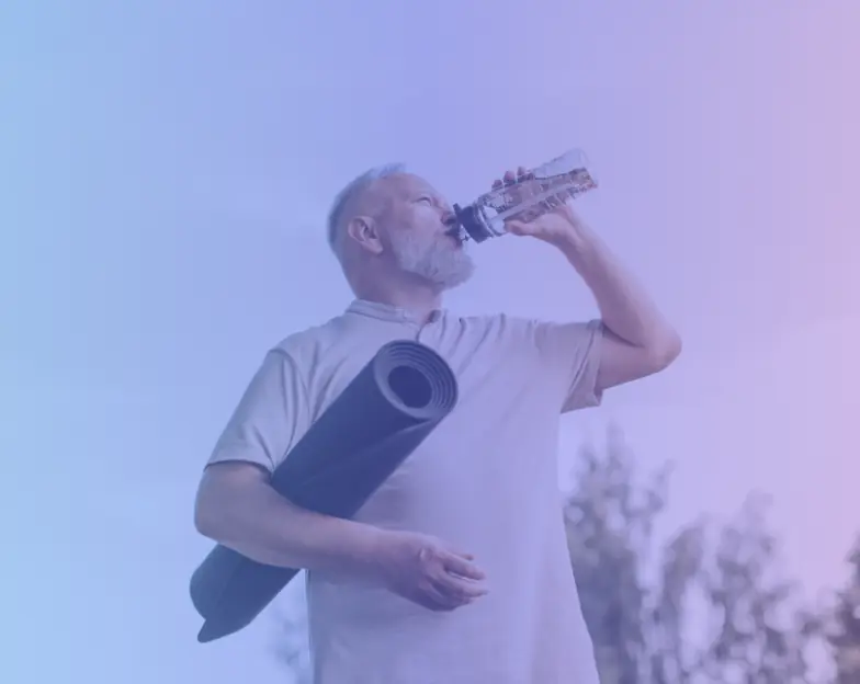 Medical and dental marketing in UAE: Man holding an exercise mat and drinking from a bottle for Recurring Health and Lifestyle Programmes, supporting specialty-led healthcare marketing