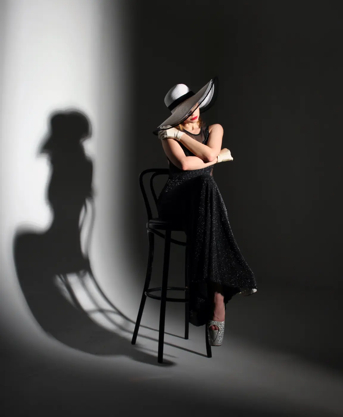 Healthcare marketing packages UAE: Model seated in a black outfit during a studio-style portrait for Build Demand. Keep Patients. Strengthen Authority, supporting retention and healthcare authority